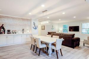 a kitchen and living room with a table and chairs at Barefoot Lizzy's in Edisto Island