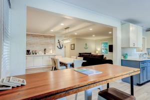 a kitchen and living room with a table and a dining room at Barefoot Lizzy's in Edisto Island +25 photos