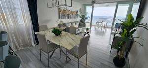 a dining room and living room with a table and chairs at Oceanfront 3-bedroom Sub-Penthouse in Luquillo PR in Luquillo