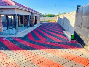 a carpet on the ground in front of a building at Diana's Place Guest house in Nyanda +9 photos