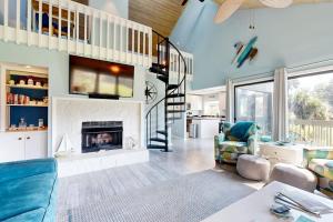 a living room with a staircase and a fireplace at Breath'n Easy in Edisto Beach