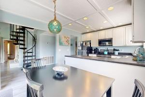 a kitchen with a counter and a table with chairs at Breath'n Easy in Edisto Beach