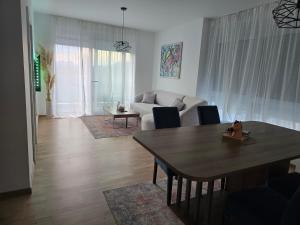 a living room with a table and a couch at Mare Ann in Ljubuški