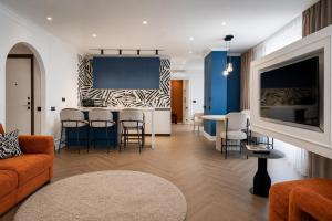 a living room with a couch and a table and chairs at Spatium Medical & Wellness Hotel in Odesa