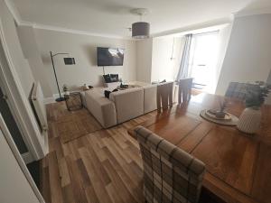a living room with a couch and a table at Close to amenities in Weston-super-Mare
