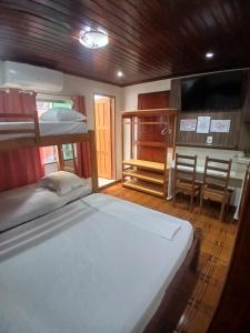 a bedroom with two bunk beds and a kitchen at Pousadas JC 1 AP completo in Santarém