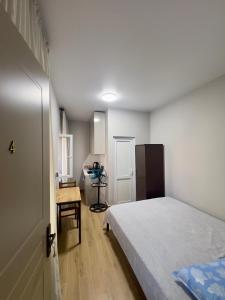 a bedroom with a bed and a desk in it at Maya Seaside Ureki in Ureki