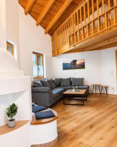 a living room with a couch and a table at NaturZeit Melleck in Schneizlreuth