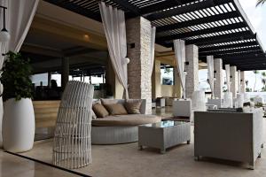 a lobby with a couch and chairs and tables at Royalton CHIC Punta Cana, An Autograph Collection All-Inclusive Resort & Casino, Adults Only in Punta Cana