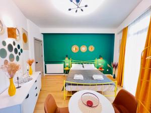 a living room with a green wall and a table at M Boutique Aparthotel in Tbilisi City