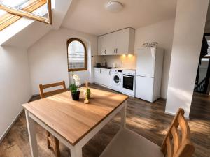 a kitchen with a wooden table and a white refrigerator at Ferien Wohnung in Traben-Trarbach