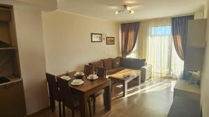 a living room with a table and a couch at Sun Sea App in Shkorpilovtsi