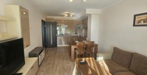 a living room with a couch and a table at Sun Sea App in Shkorpilovtsi