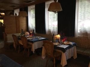 a dining room with a table and chairs with candles at Hotel Alpenrose in Alleghe