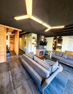 a living room with a couch and a table at Farayayellowstone 1 bedroom with panoramic mountain view fit 4 in Bayn an Nuhūr