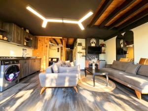 a living room with a couch and a table at Farayayellowstone 1 bedroom with panoramic mountain view fit 4 in Bayn an Nuhūr