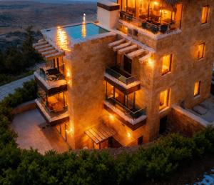 an aerial view of a house with a swimming pool at Farayayellowstone 1 bedroom with panoramic mountain view fit 4 in Bayn an Nuhūr