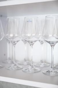 a row of wine glasses sitting on a shelf at Michell Apartman Martin in Martin +19 photos