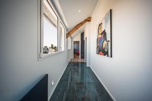a hallway with white walls and large windows at appartement Picasso - une évasion face à l'océan in Santec +31 photos