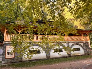 a stone wall with a balcony on top of it at Chata Salamandra in Michalovce