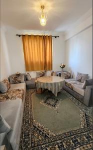 a living room with a couch and a table at Résidence Erahha in Agadir