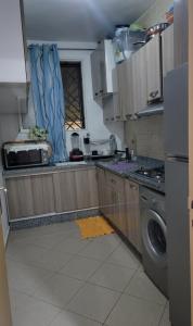 a kitchen with a sink and a dishwasher at Résidence Erahha in Agadir