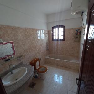 a bathroom with a sink and a toilet and a tub at Banana Guest House in Luxor +54 photos