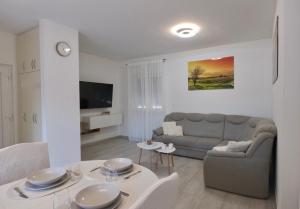 a living room with a couch and a table at Bokun Gušta in Trogir