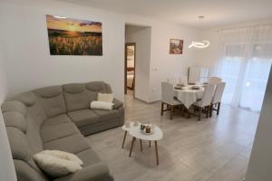 a living room with a couch and a table at Bokun Gušta in Trogir