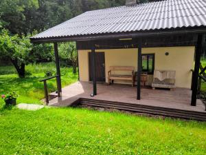 a gazebo with a bench in a yard at Sauna Suite 1 in Valga +6 photos