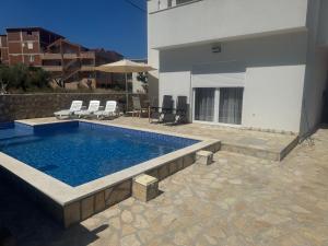 a swimming pool in front of a house at Lux Villa Azur in Bar