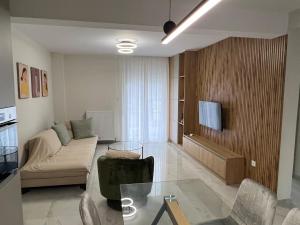 a living room with a couch and a table at GreveLuxious in Grevena