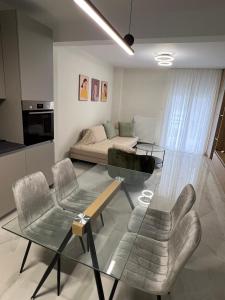 a living room with a couch and a glass table at GreveLuxious in Grevena
