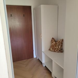 a room with a door and a shelf with a pillow at Ferienwohnung mit Bergblick in Oberammergau