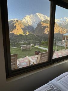 a view of a mountain from a bedroom window at KOH E QAF HUNZA in Hini