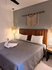 a bedroom with a bed with a swan on it at Ah Xok suites 5a Avenida in Playa del Carmen +61 photos