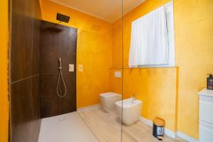a bathroom with a shower with a toilet and a sink at Robur Gardae Panoramic Suite in Torri del Benaco