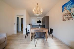 a dining room and kitchen with a table and chairs at Robur Gardae Panoramic Suite in Torri del Benaco