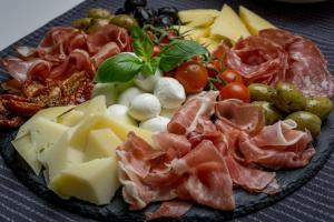 a plate of food with meat cheese and other foods at Pietramarina162 in Camerota