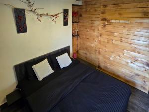 a bedroom with a black bed with two white pillows at Farayayellowstone 1 bedroom with panoramic mountain view fit 4 in Bayn an Nuhūr +20 photos