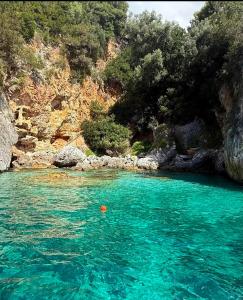 a pool of turquoise blue water next to a mountain at Pietramarina162 in Camerota +41 photos