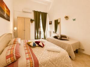 a bedroom with two beds and a window at Bed and Breakfast Station in Brindisi