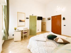 a bedroom with a large bed and a desk at Bed and Breakfast Station in Brindisi +22 photos