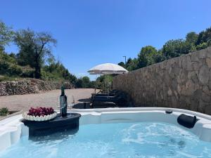 a hot tub with a bottle of wine and a bowl of fruit at Hidden House Porta in Krk