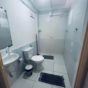 a white bathroom with a toilet and a sink at Pousada Dipajuçara in Maceió +11 photos