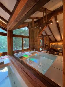 a jacuzzi tub in a wooden house at Rêve sur le lac in Rhêmes-Notre-Dame
