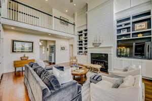 a living room with white furniture and a fireplace at Luna Sea in Edisto Beach