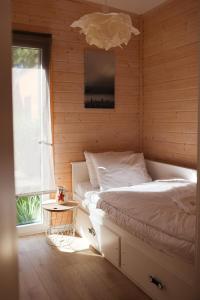 a bedroom with a white bed and a window at Seaside Harmony in Pogorzelica +98 photos