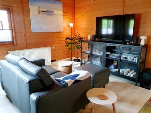 a living room with a couch and a flat screen tv at Zeit für uns in Cuxhaven