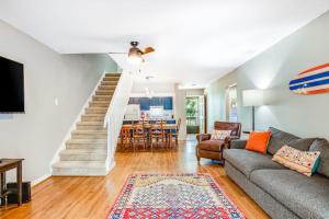 a living room with a couch and a dining room at The Pirate Den in Edisto Beach